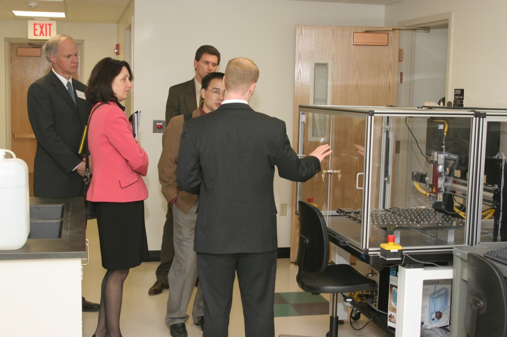 Graduate student, Joshua Suhl, leads a tour of the CAGT, explaining the Affymetrix Gene Machine chip printing robot.